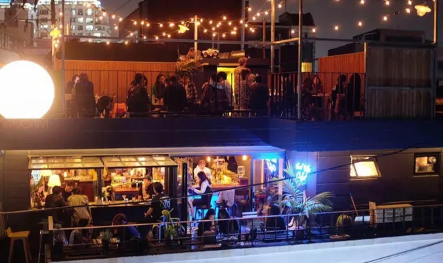 ARUGAM rooftop and counter bar glowing at night in Mangwon